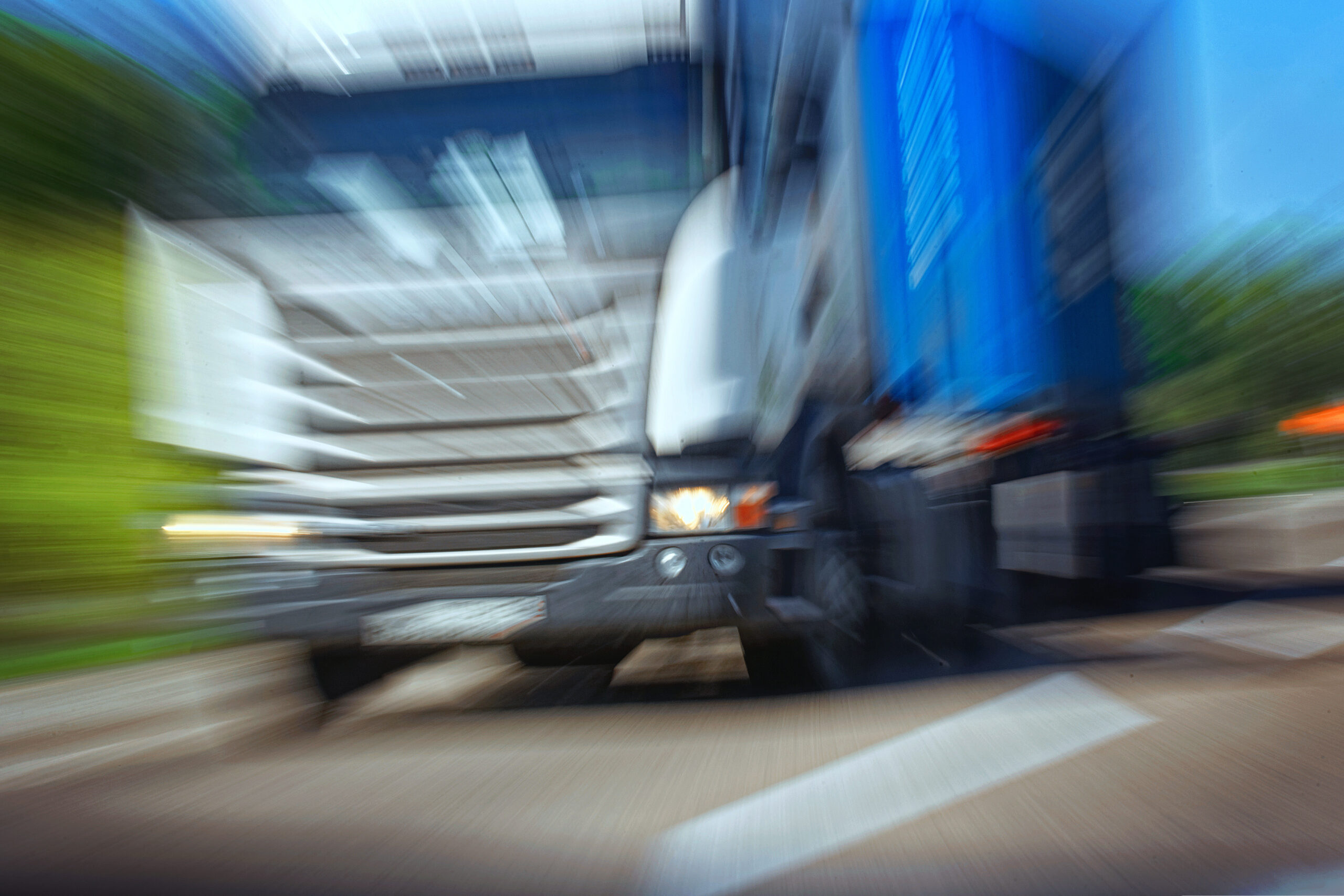 Truck in a blur on the road in motion. The danger of a collision or emergency situation. Violation of rules by truckers